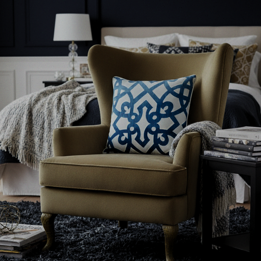 Brown armchair with a decorative pillow in a bedroom setting
