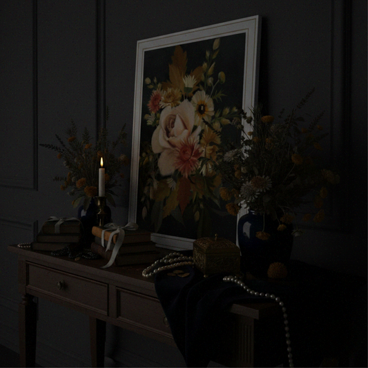 Floral artwork on a dark wall with decorative items on a table.