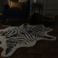 Zebra print rug in a dimly lit room with furniture.